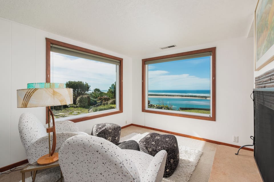 Curl up in your cozy reading nook with stunning ocean views through dual windows, perfect for morning coffee or evening relaxation.