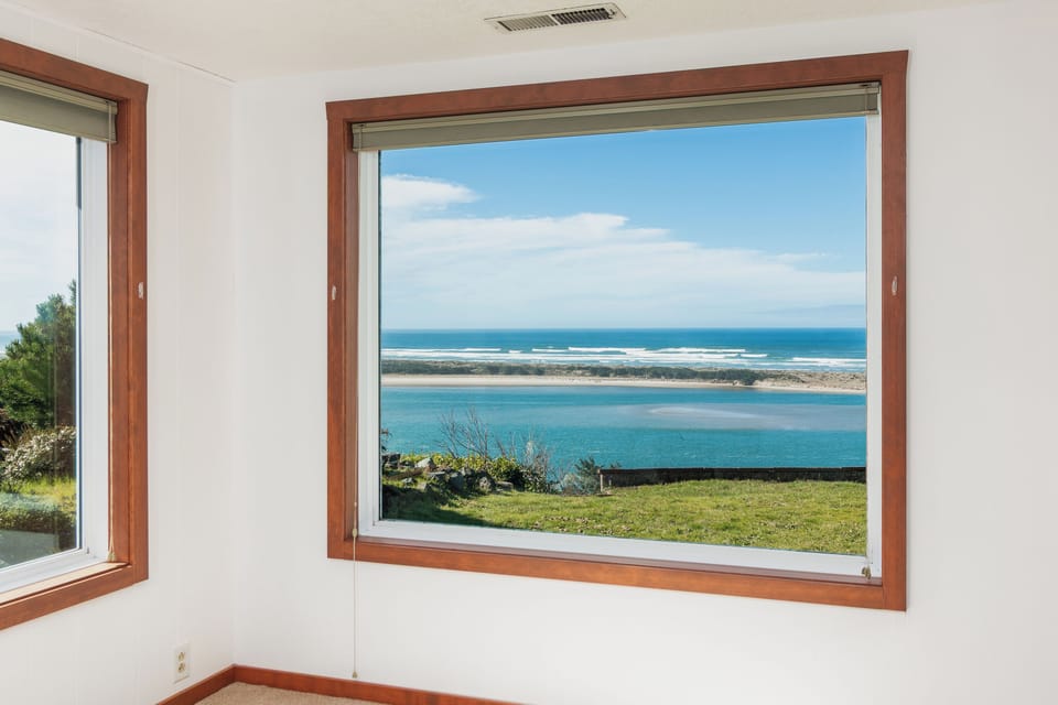 Wake up to breathtaking ocean views through your expansive picture window, where endless blue waters meet pristine coastline right outside your room.