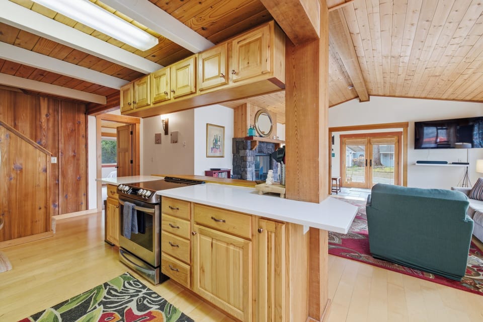 Rustic charm meets modern comfort in your open kitchen with warm wood beams and granite counters.