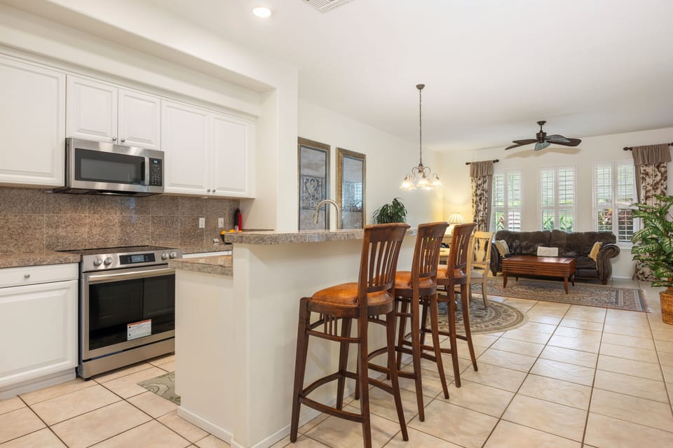 Enjoy cooking in your fully equipped kitchen with granite countertops and breakfast bar seating overlooking the comfortable living area.