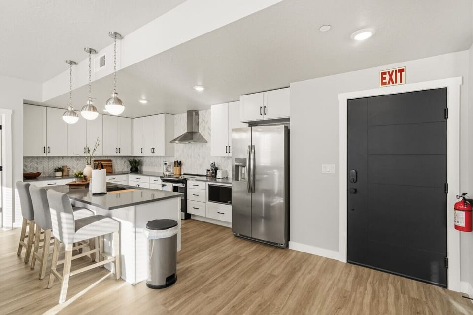 Open kitchen with island seating and stainless steel appliances