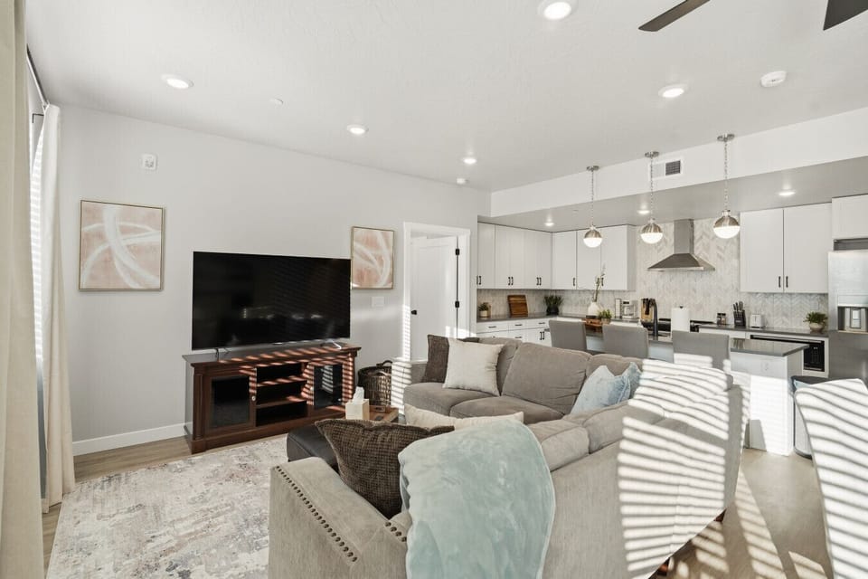 Open living room with sectional seating and kitchen views