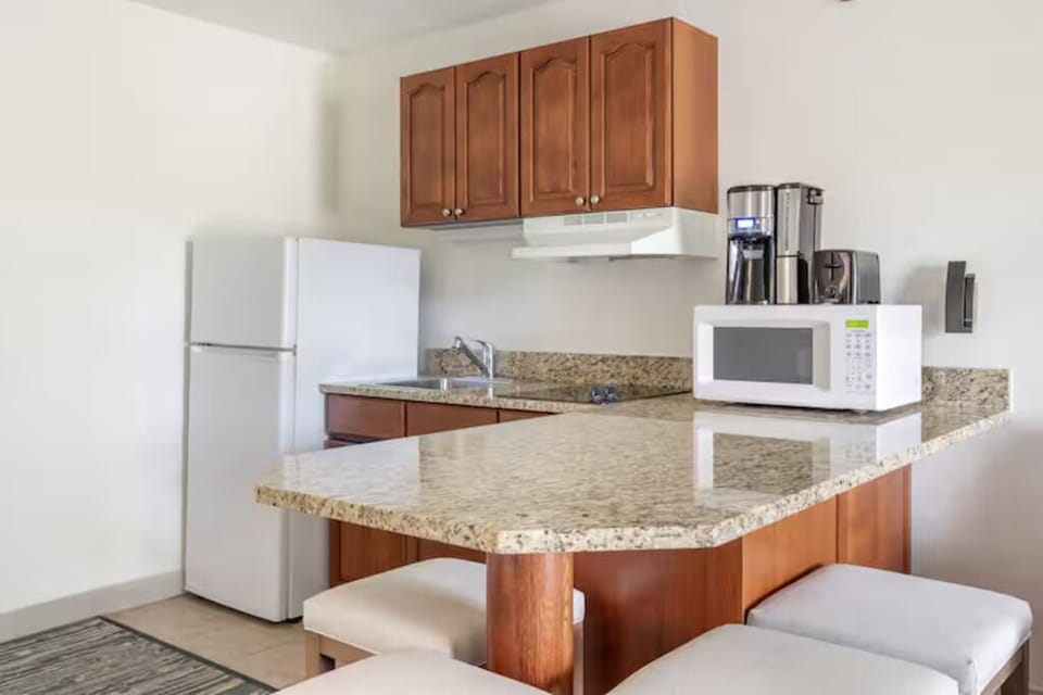 Enjoy quick meals with granite counters, fridge, and microwave.