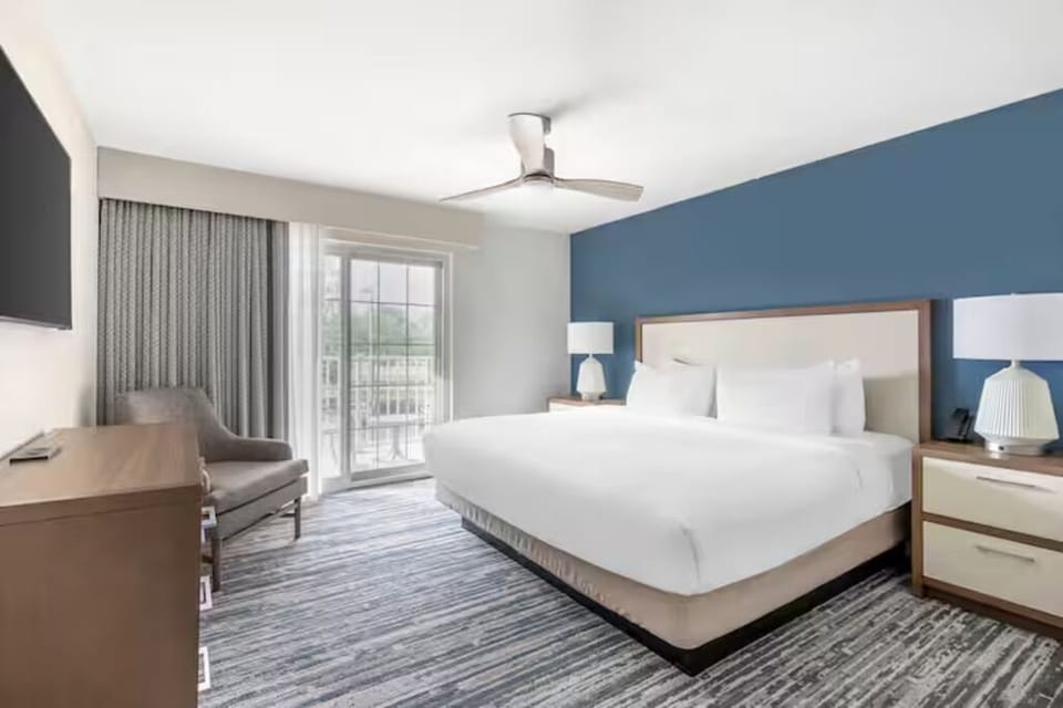 Wake up to fresh air through bright balcony doors.