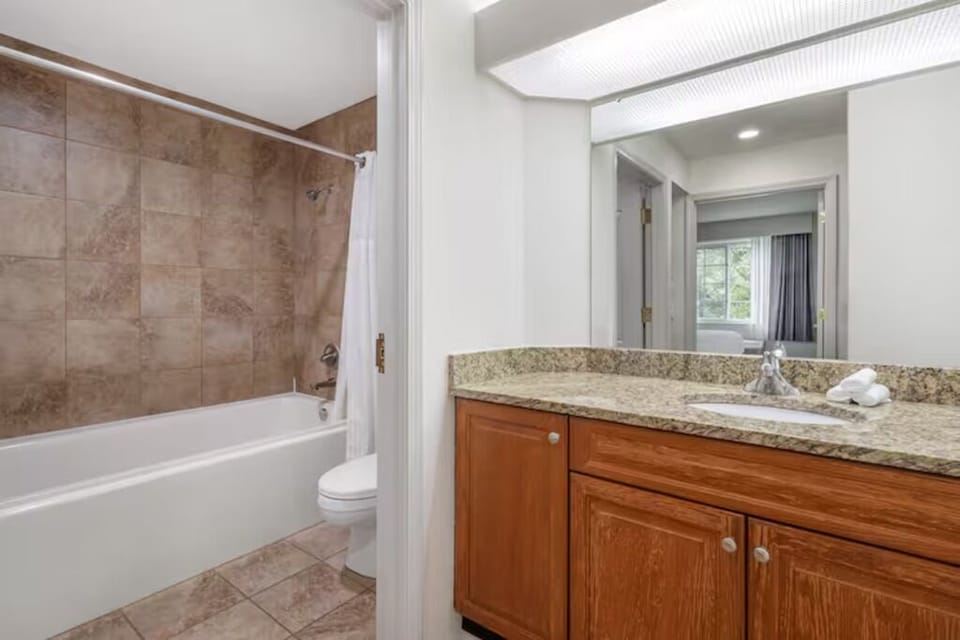 Refresh after adventures with a bright vanity and shower-tub combo.