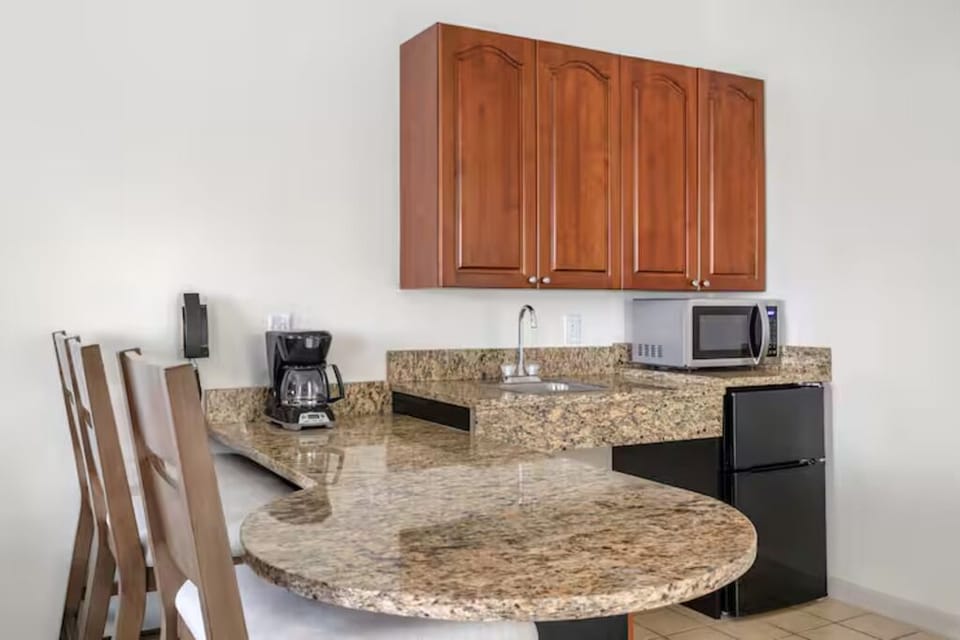Whip up easy meals on sleek granite counters and bar seating.