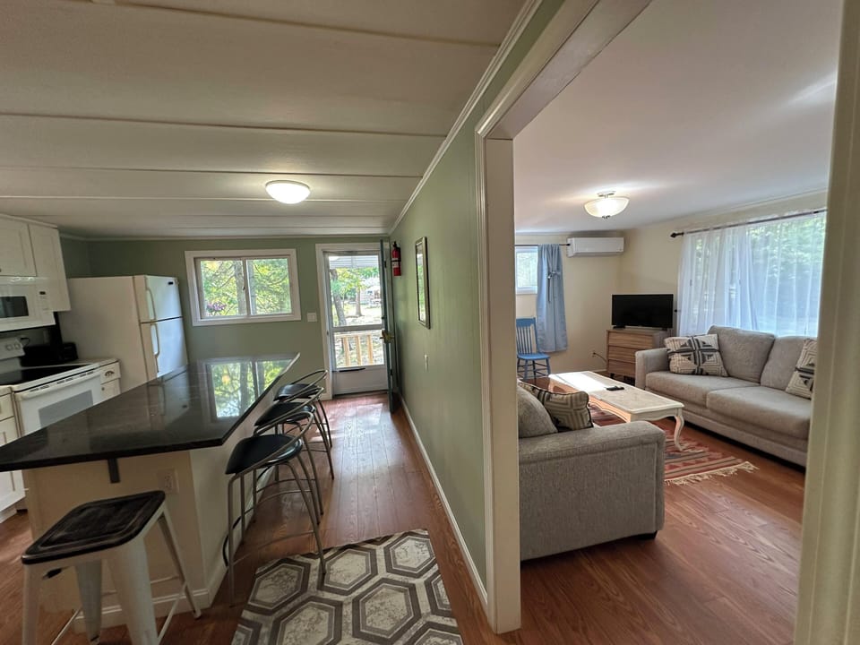 Step into your cozy open-concept retreat where the modern kitchen flows seamlessly into your comfortable living space, perfect for relaxing after exploring.