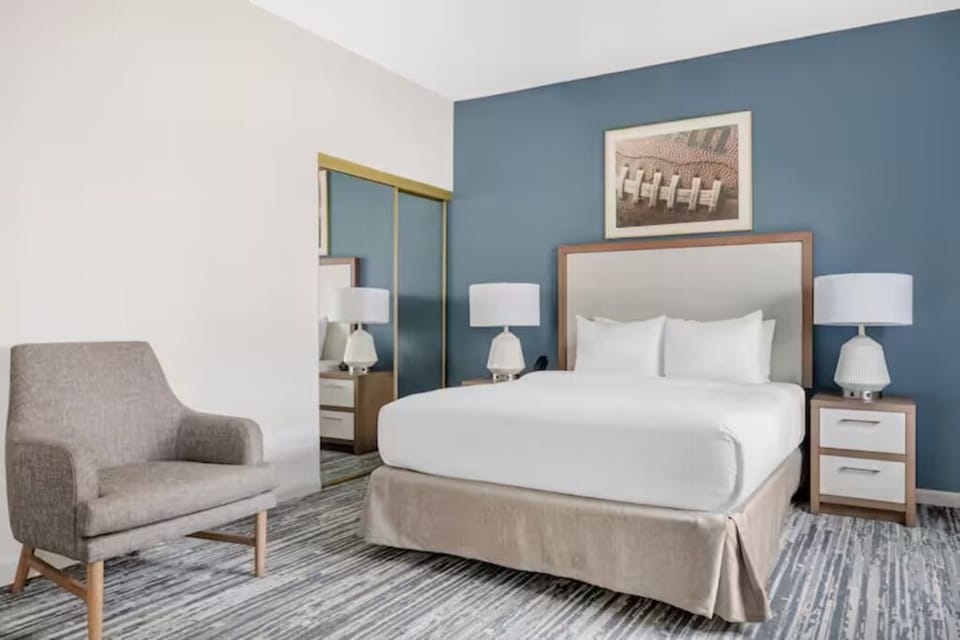 Sink into a plush bed framed by modern, soothing decor