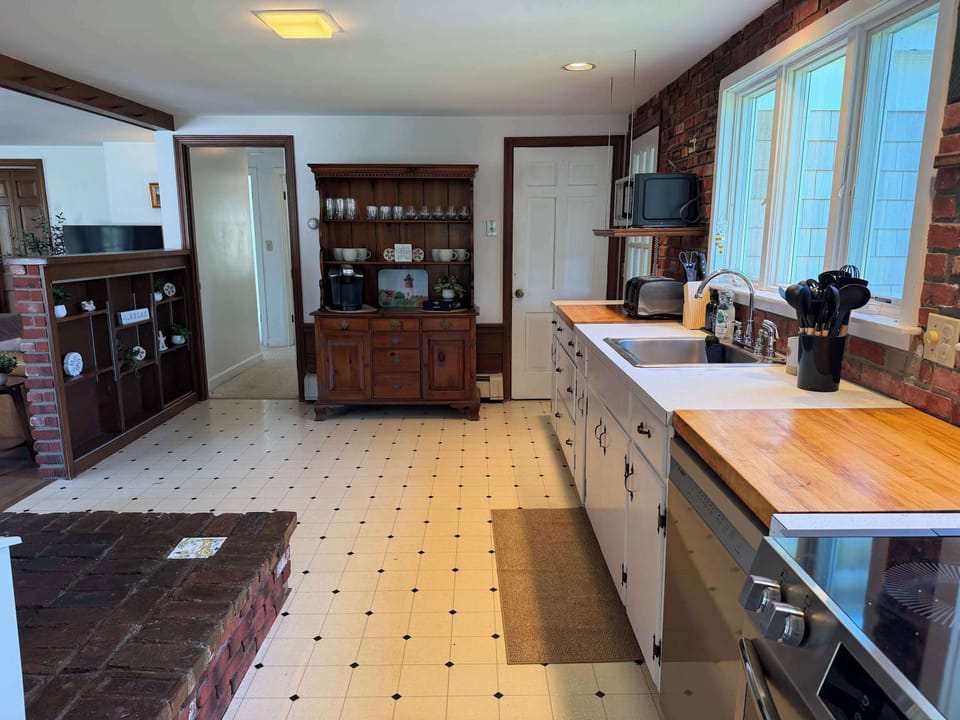 The kitchen is fully stocked, with plenty of storage and butcher block countertops.