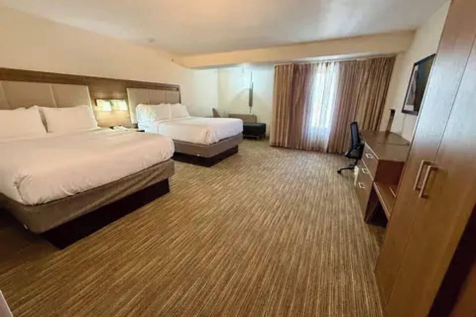 Take in the roomy layout with beds and workspace in view.