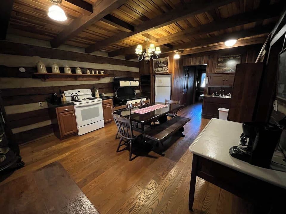 The kitchen includes a larger dining table, as well as a full bathroom and laundry room down the hallway.