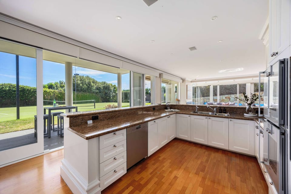 An entertainer's dream with bright, functional kitchen overlooking the court and outdoor entertaining areas
