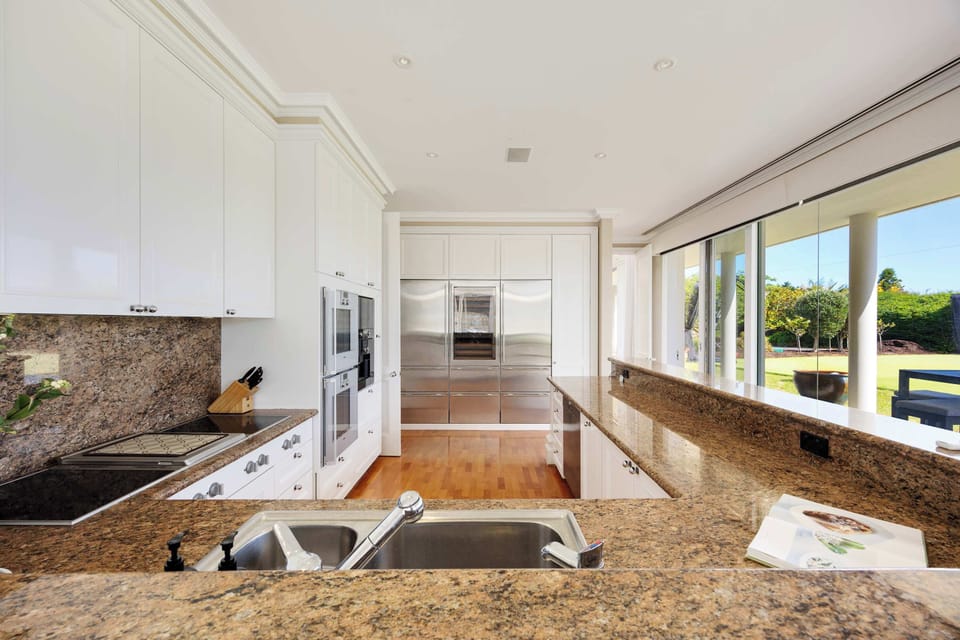  Fully equipped gourmet kitchen with GAGGENAU stovetops, electric double ovens, integrated microwave and espresso machine. Also Triple SUBZERO fridge/freezer with climate‑controlled wine storage