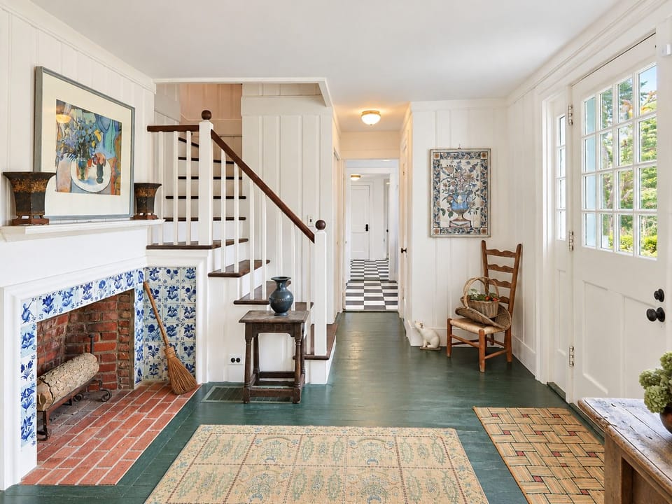 Entry hall with tiled fireplace and stairs to the second floor