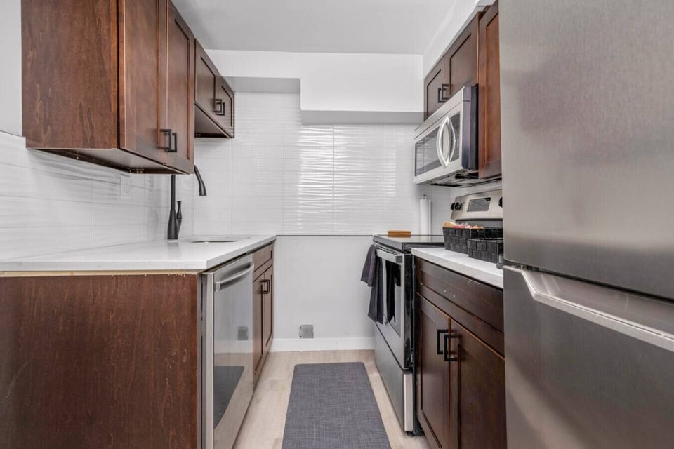 Modern kitchen with stainless steel appliances and ample counter space.