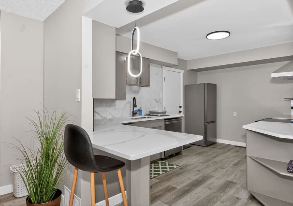 Modern kitchen with island seating and clean contemporary finishes.