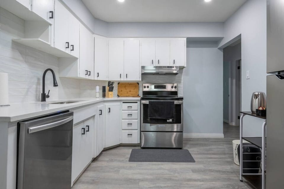 Spacious kitchen with stainless steel stove and ample cabinet space.