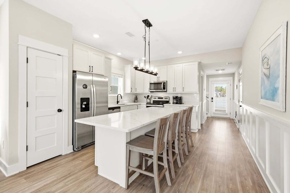 Kitchen: Modern appliances, sleek finishes, and a breakfast bar for easy meal prep and casual dining.