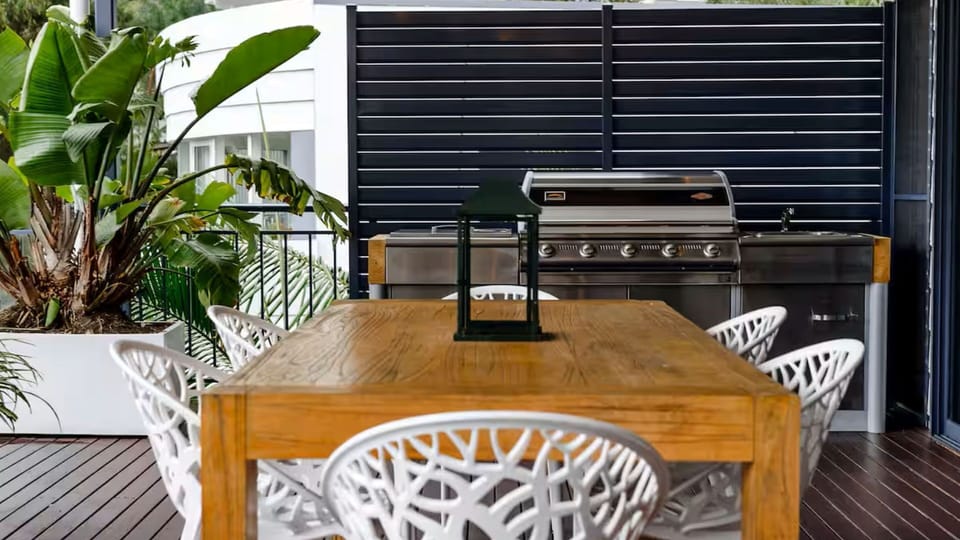 Outdoor dining area with BBQ ideal for meals and entertaining.
