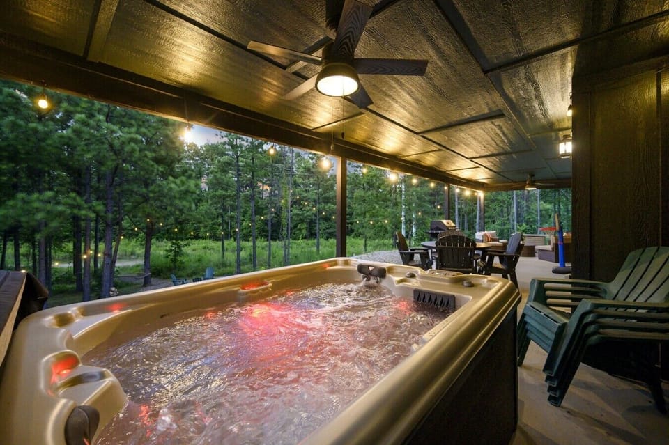 Private hot tub tucked under the covered patio for relaxing in any season.