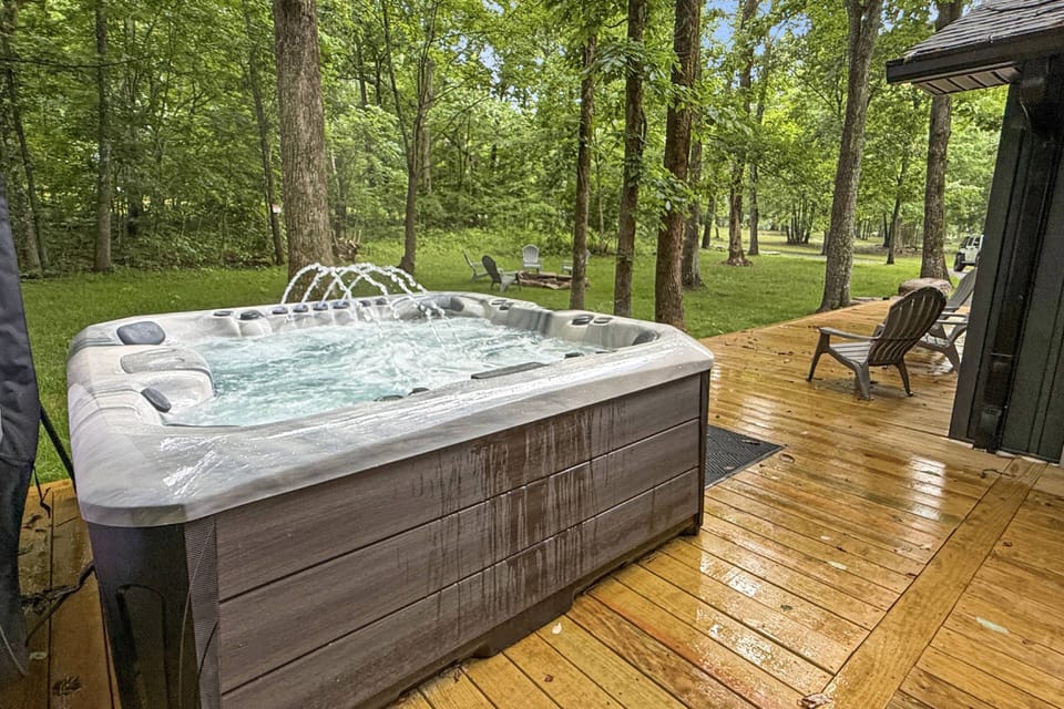 Enjoy the 8-seat hot tub steps away from the fire pit area