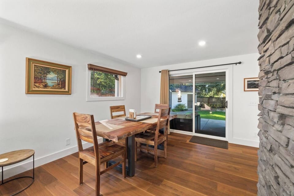 Main dining table seats six (with two additional chairs available), centrally located between both living areas.
