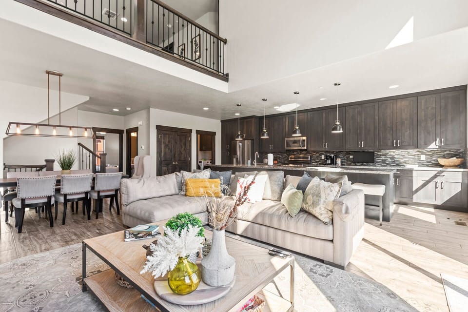 Relax in your spacious open-concept haven where modern comfort meets rustic charm, featuring soaring ceilings and thoughtful design throughout.