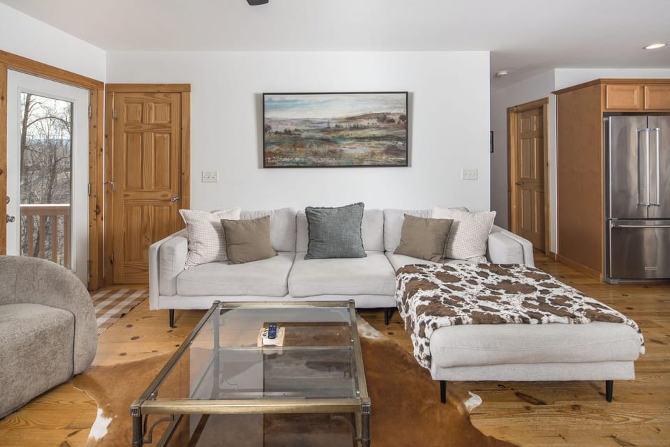 An open layout that allows the group to stay connected between the sofa and the stove.