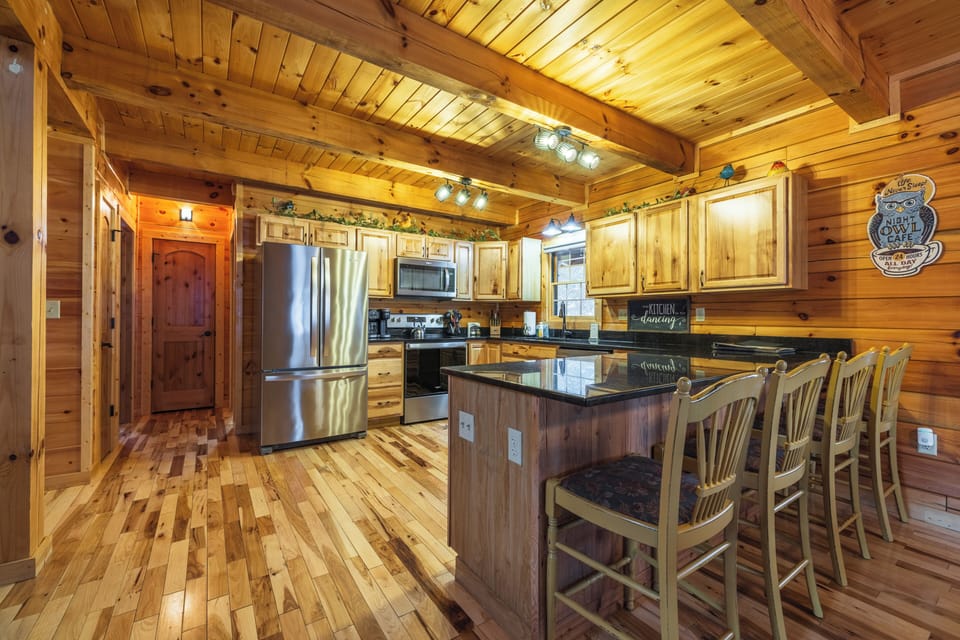 Stools at the kitchen island offer a casual spot to chat while meals are being prepared.