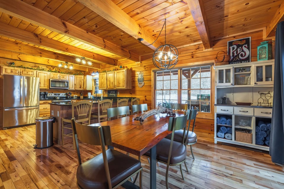 The open floor plan allows for easy movement between the kitchen and the large dining table.