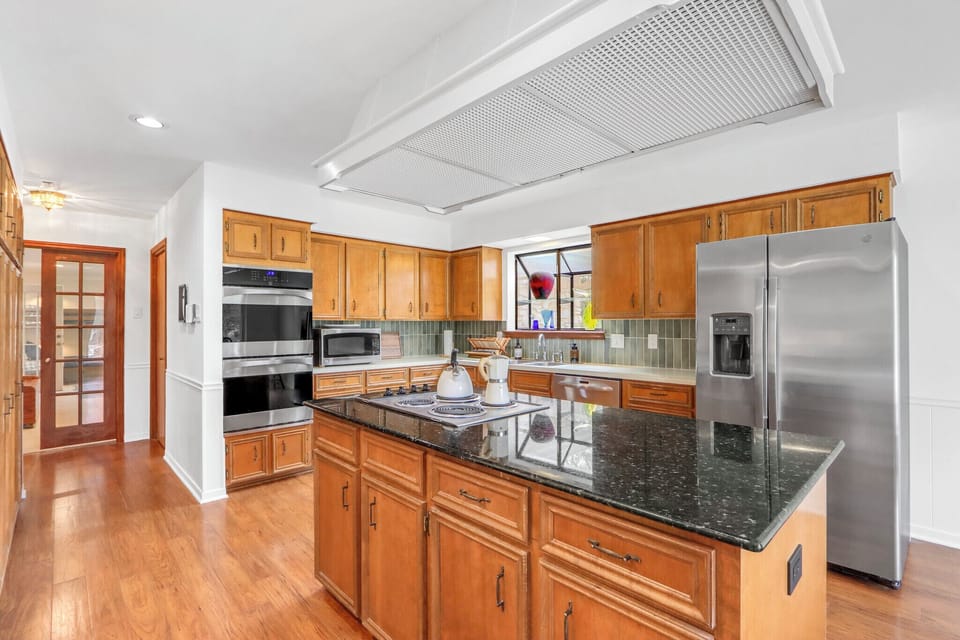 Your gourmet kitchen features granite countertops, warm wood cabinetry, and stainless steel appliances—perfect for creating memorable meals together.