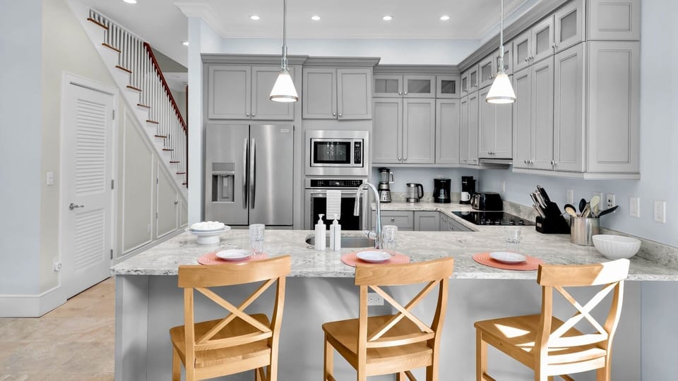 Gather around the kitchen bar for morning coffee or casual meals...