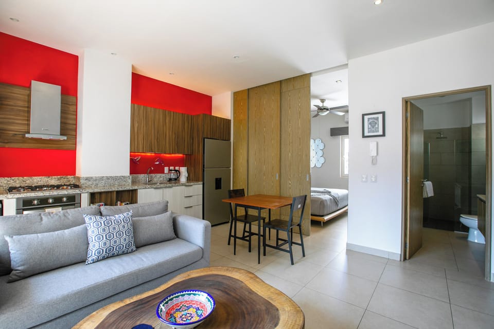 Your open-concept studio combines modern comfort with vibrant style, featuring a sleek kitchen, cozy living area, and sliding door in the bedroom area