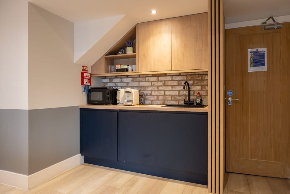 Comfortable studio with kitchen facilities, including tea, coffee, and microwave for a convenient stay.