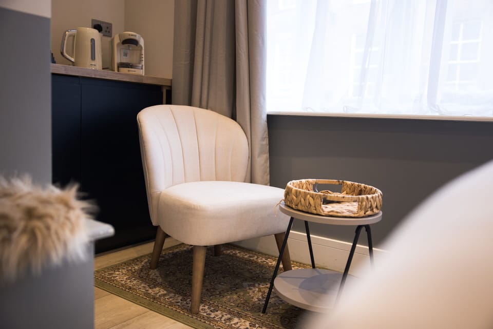 Comfortable studio chair and coffee table for your relaxing stay.