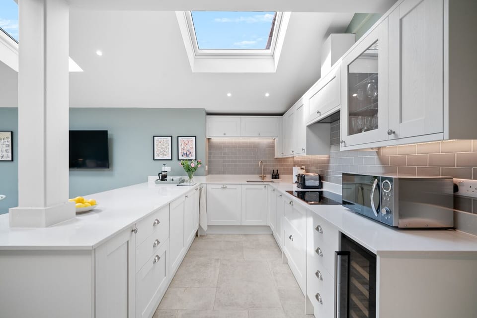 Fully fitted kitchen, 2 ovens, microwave, dishwasher, breakfast bar to dining area and sofa space