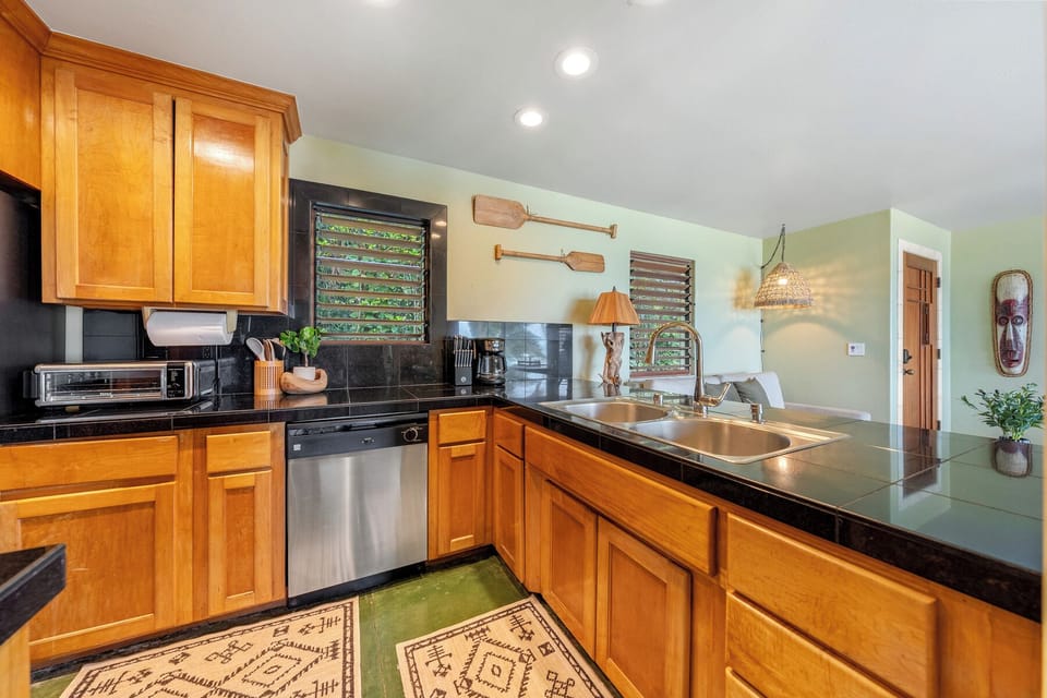 Your fully equipped kitchen features warm wood cabinets for preparing tropical meals together.