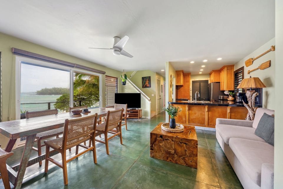 Unwind in your open-plan living space where tropical ocean views frame every meal and moment of relaxation.