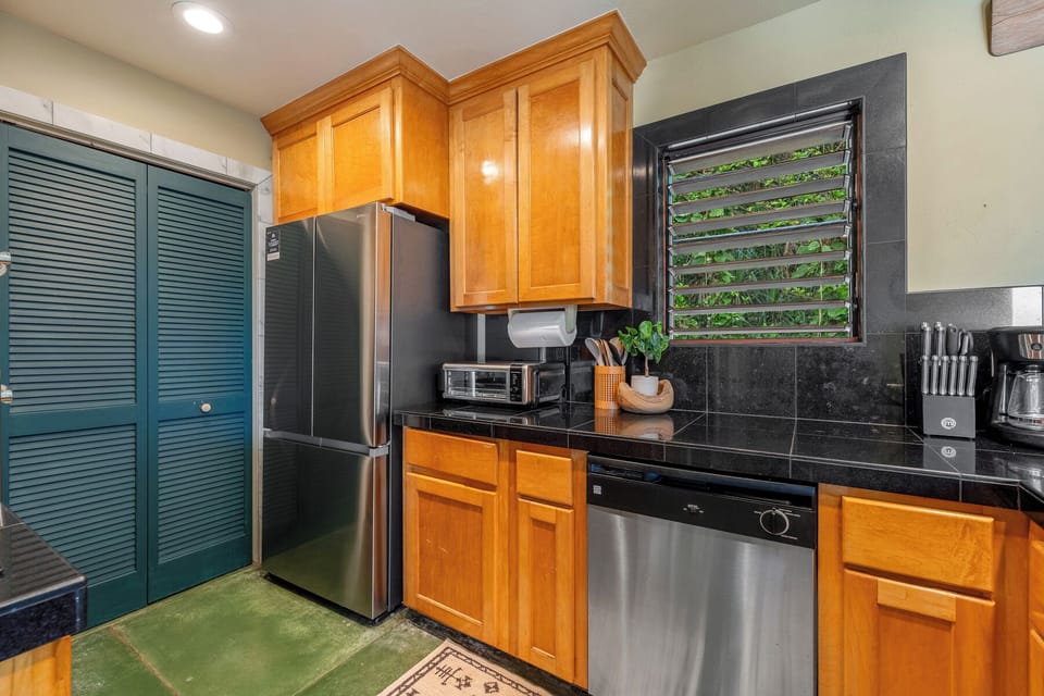 Your fully equipped kitchen features warm wood cabinets and a perfect setting for preparing delicious meals during your stay.