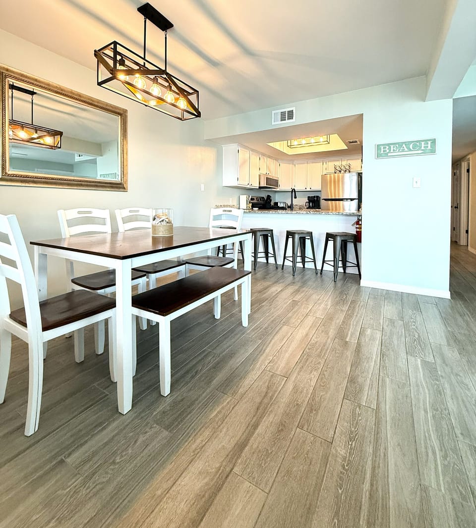 Fully equipped kitchen and dining area with seating for gathering and meals.
