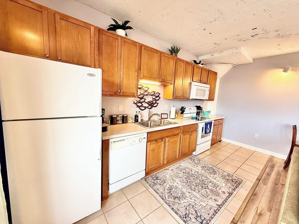Functional kitchen with full-size appliances, ample counter space, and everything needed for cooking or quick meals during your stay.