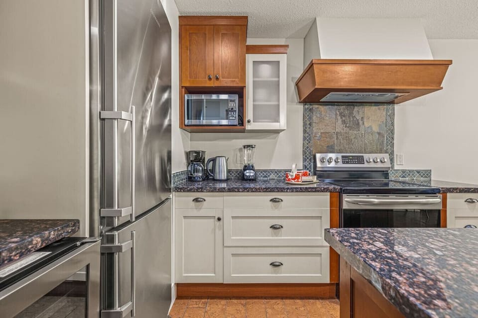 Spacious kitchen with stainless steel appliances.