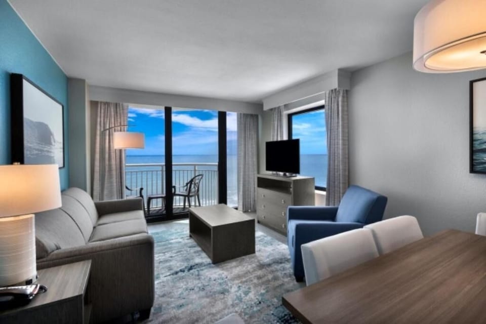 Gather by the windows and soak in sweeping sea views.