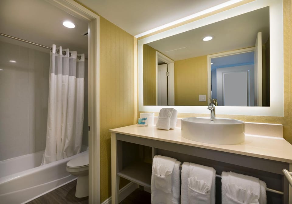 Refresh effortlessly with bright vanity lighting and fluffy towels.