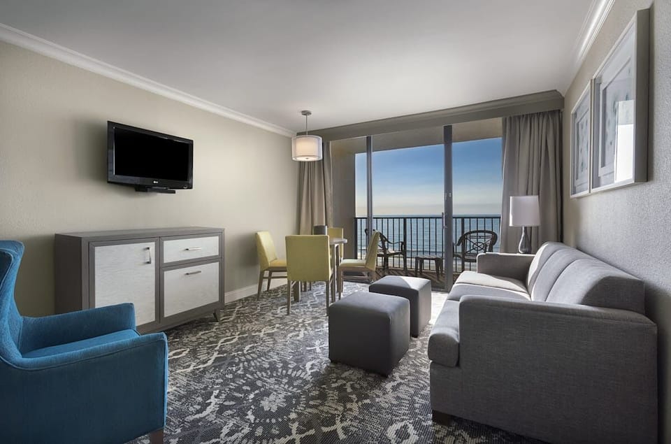 Lounge together with ocean views just beyond the balcony.