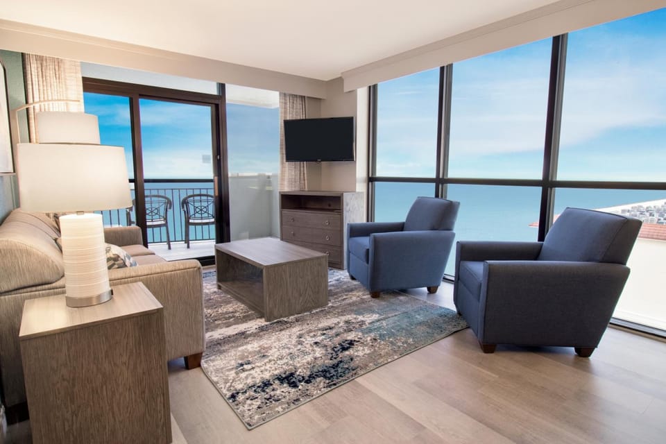 Unwind on cozy seating with wall-to-wall ocean scenery.