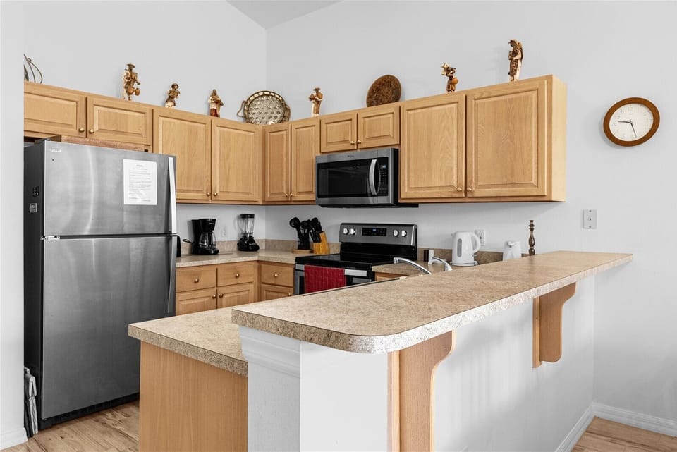 Kitchen With Fridge, Microwave, & Stove