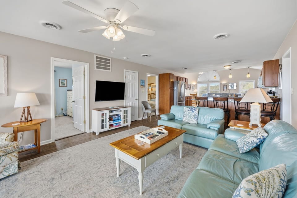 Relax in your spacious living room with comfortable seating, entertainment center, and open flow to the fully-equipped kitchen.