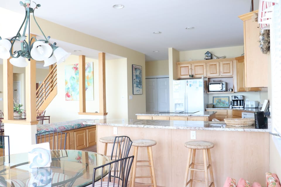 Your spacious kitchen opens to the dining area, creating perfect flow for cooking and entertaining with warm wood details throughout.