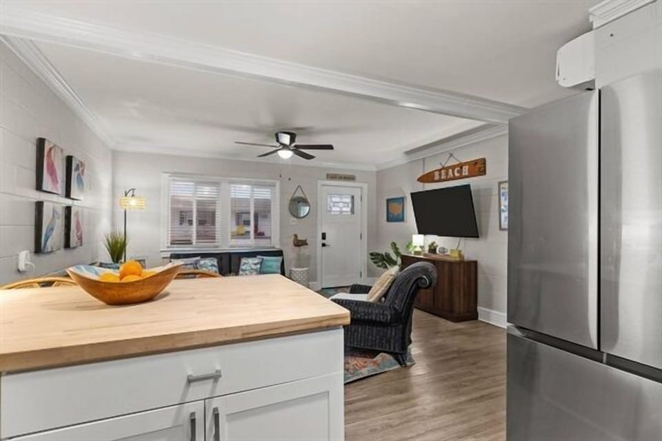 Unwind in your bright, modern living space with sleek kitchen island, cozy seating, and everything you need for a perfect stay.